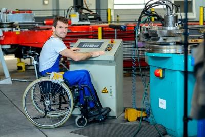 disabled man in wheelchair in manufacturing