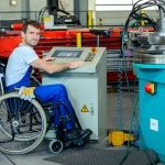 disabled man in wheelchair in manufacturing