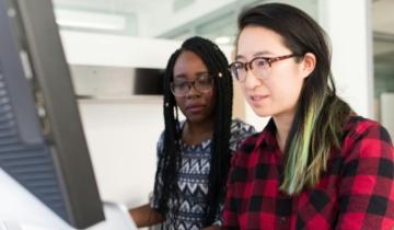 Two Coworkers at a Computer